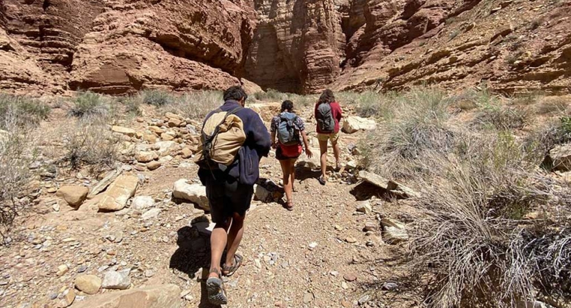 a group of gap year students hike in the southwest on an outward bound course